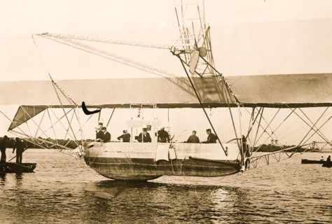 Men inside basket of Zeppelin airship, on water 1908