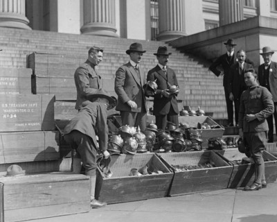 Men unload Prussian Helmets  1919