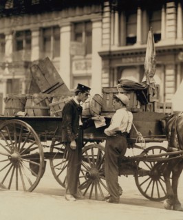 Messenger boys in conversation at Union Square, N.Y. Location: New York, New York 1910