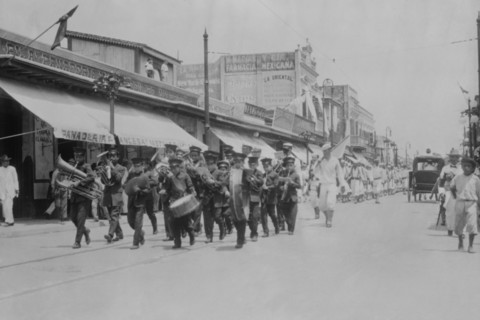 Mexican Band Plays Instruments in front of Marching Columns of US Navy Sailors