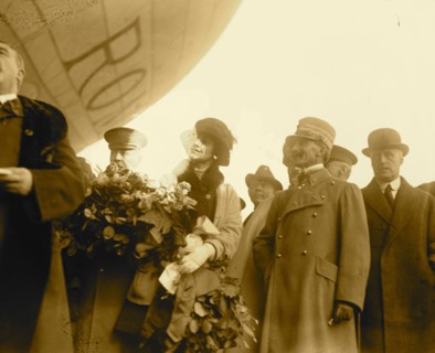 People standing under dirigible