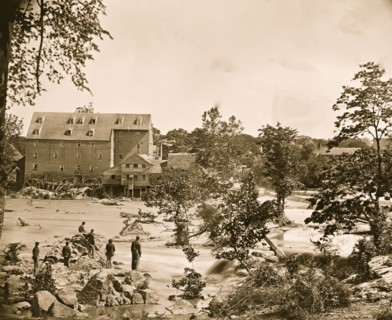 Petersburg, Va., vicinity. Johnson's Mill on the Appomattox near Campbell's Bridge; soldiers standing on rocks in the stream 1865