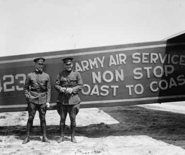 Pilots pose in front of a Plane that they fly coast to coast 1923