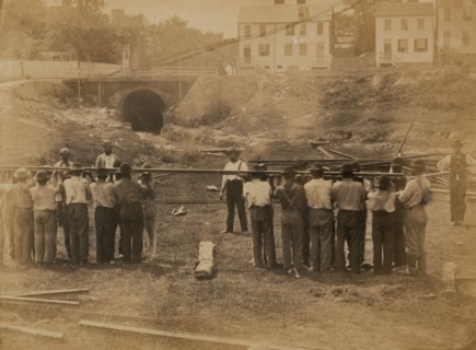 Railroad construction workers straightening track 1863