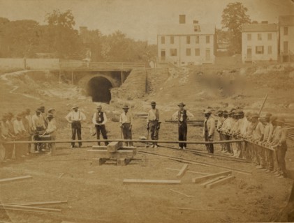 Railroad construction workers straightening track 1863