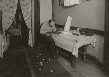 Rolling cigarette cases in tenement home. 1912