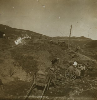 Russian supply carts at the base of a hill; on the hill, a Red Cross field post with wagons for transporting the wounded 1905
