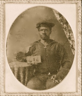 Sailor with cigar in hand holding a double case image of confederate soldiers 1865