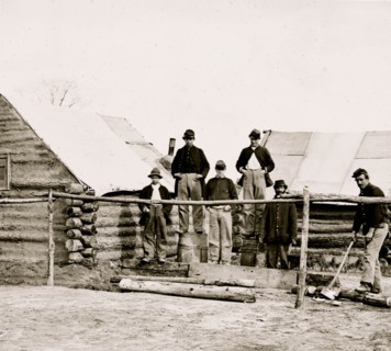 Soldier chopping wood in camp 1863