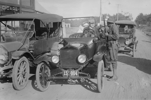 Soldier with Rifle confronts a vehicle with civilians