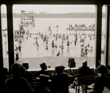 Spectators in a Shore Pavillion overlook the swimmers and divers in the Washington Tidal Basin 1923