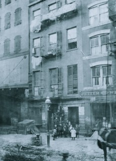 Tenement house with children in front. Possibly 36 Laight St. 1910