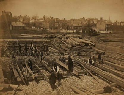 Track near the Potomac River, in Alexandria. Lumber; part of construction force at work 1863