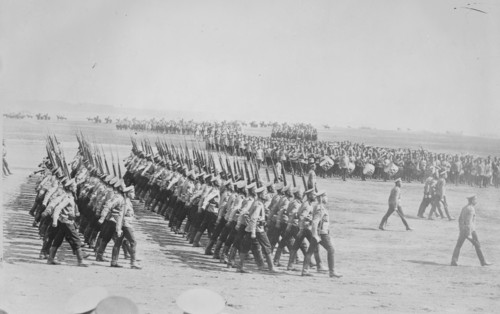 Tsarist Troops parade and pass in Review in Formation across field while a marching band plays 1907