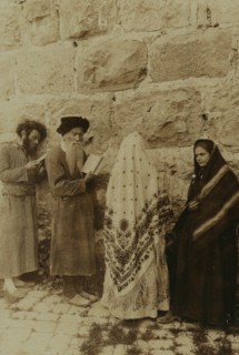 Two Jewish men and two women standing in front of the Wailing Wall, Jerusalem 1908