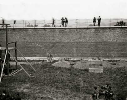 Washington, D.C. Coffins and open graves ready for the conspirators' bodies at right of scaffold 1865