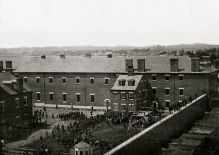 Washington, D.C. Execution of the conspirators: scaffold in use and crowd in the yard, seen from the roof of the Arsenal 1865