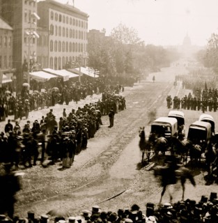 Washington, D.C. Group of ambulances followed by band and infantry units on Pennsylvania Avenue near the Treasury 1865