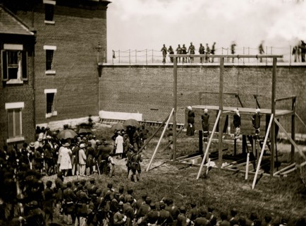 Washington, D.C. Hanging hooded bodies of the four conspirators; crowd departing 1865