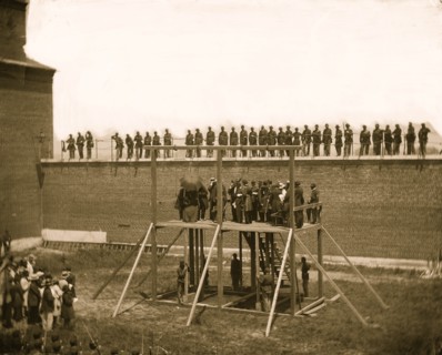Washington, D.C. The four condemned conspirators (Mrs. Surratt, Payne, Herold, Atzerodt), with officers and others on the scaffold; guards on the wall 1865