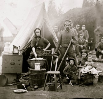 Washington, District of Columbia. Tent life of the 31st Penn. Inf. (later, 82d Penn. Inf.) at Queen's farm, vicinity of Fort Slocum; husband and wife with Children and a baby; wife does wash 1861