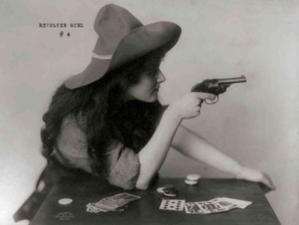 Young Cowgirl Hold Pistol Over a table of Playing Cards 1912