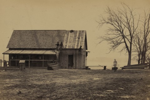 Workers constructing a wood building 1863