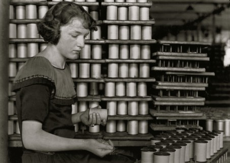 Young Girl stacks spools of silk thread 1924