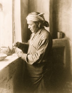 Zuni Indian bead worker drilling holes in beads 1903