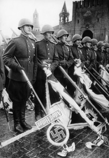 Red army soldiers holding nazi banners during ve day celebrations in red square in moscow at the end of world war 2, 1945.
