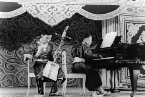 Mongolian musician dzhamyan performs a piece by schumann on a two stringed folk instrument called a marinkura (horse head fiddle), moscow, ussr, september 1947.