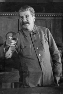 Joseph stalin giving a speach at a session of the commission for studying the project of the model constitution of agricultural artels during the second all-union congress of collective farm shock-wor...