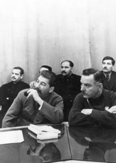 Joseph stalin (front, left) sits with k,e, voroshilov at a conference of best combine workers and soviet government, left to right, back: a,a, andreyev, l,m, kaganovich, v,j, chubar, ussr, 1930s.
