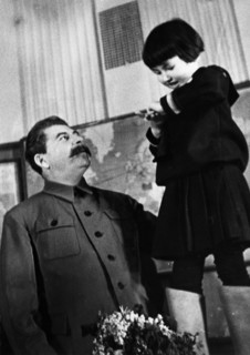Joseph stalin receiving a bouquet of flowers from engelsina (gelya) markizova, the 7-year-old daughter of the second secretary of the buryat-mongolian regional party committee in 1936, stalin had him ...