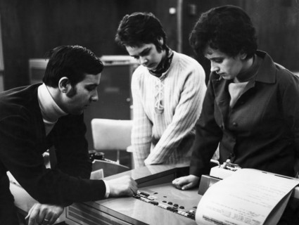 Students j, jankowska and cz, debicka discussing the workings of a digital computer with their instructor, j, wolanski at the laboratory of the center of perfection of the technical personnel in wrocl...