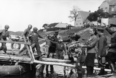 Soviet red army troops meeting the troops of the 1st american army as they cross the elba river near torgau, germany on april 25, 1945.
