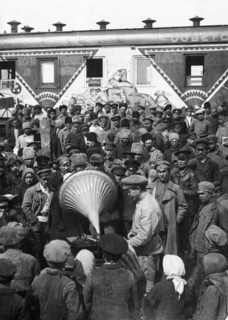 People listening to a speach of a people's commissar being played on a gramaphone, 1920, propaganda train bringing movies and recordings to to reach and instruct the peasantry.
