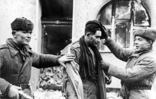 The german officer, who tried to escape in civilian dress, was taken prisoner by these two soviet tommy-gunners.