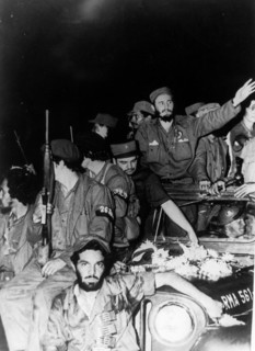 Newly victorious fidel castro ruz entering havana at the head of his revolutionary army, cuba, 1959, juan almeida bosque is behind him in profile.