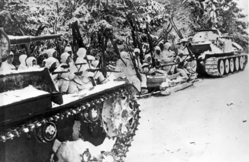 Red army skiers riding on sledges and tanks to the advanced lines, during world war ll.