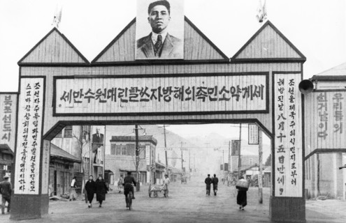 Portrait of kim il sung over a street in the town of kaishu, north korea, may 1947.