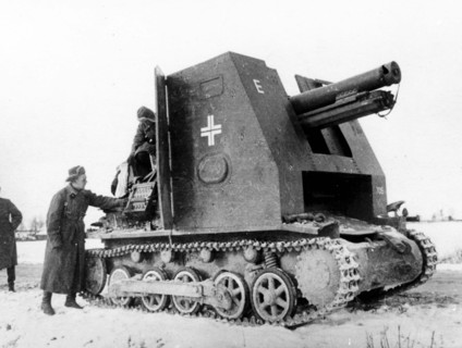 Somewhere in russian in march 1942, soviet soldiers look over a piece of captured nazi artillery mounted on an armored tractor.