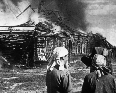 World war 2, soviet women watch as their homes burn with fire set by retreating germans.
