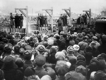 World war 2, december 19, 1943, still from a film on the kharkov trial produced by artkino, long shot of the execution, a truck was driven under the gallows, a chair placed on it, and the criminal on ...
