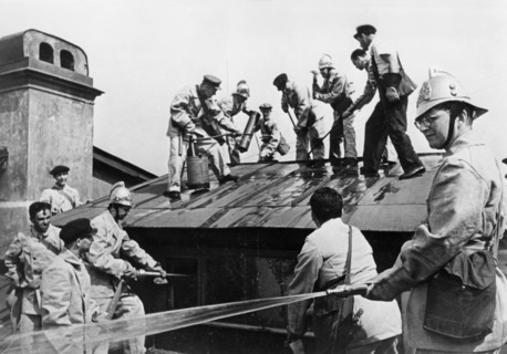 world war ll, composer dmitri shostakovich (right), member of the volunteer fire fighting squad of the leningrad conservatory, during a drill in which he and the other teachers learn to handle incendi...