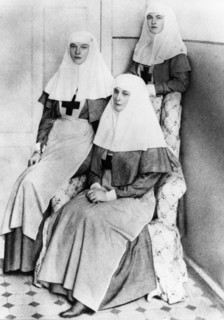 Empress alexandra and her daughters olga and tatiana after finishing the complete nursing course and receiving diplomas from the international red cross, 1914.