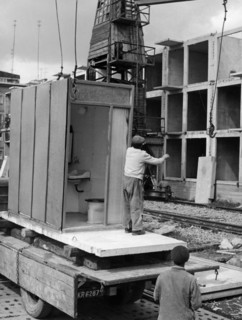 A prefab bathroom unit about to be put into place on a block of flats being constructed in nowa huta in the krakow province in poland, september 1962, these buildings are being constructed using an ex...