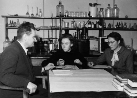 Professor dr, antoni basinski, chairman of the faculty of physical chemistry at the mikolaj kopernik university in torun, poland, giving an exam to maria kaliska and krystyna kedzierska, two graduate ...