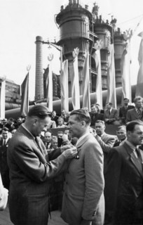 Piotr jaroszewicz, vice-chairman of the polish council of ministers, decorating engineer kiersnowski with the 'standard of labor' medal during the celebration of the opening of the big furnace at the ...