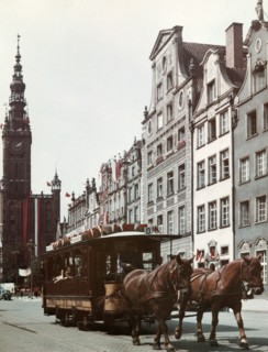 Horse drawn streetcar on a street in gdansk, poland with city hall in the background, 1965.